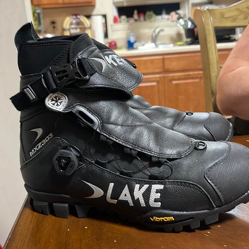 Cycling shoes great condition black leather boots by lake